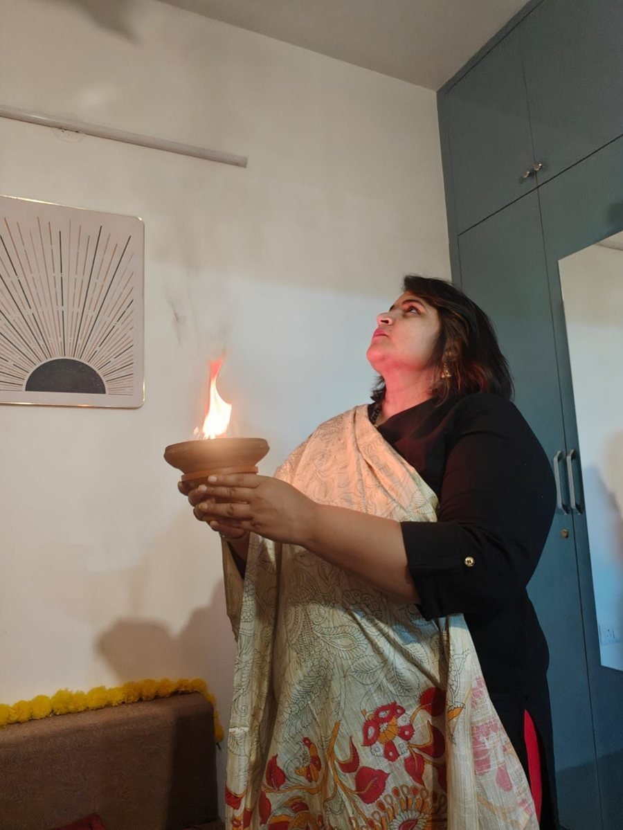 Neha Singla holding a sacred flame